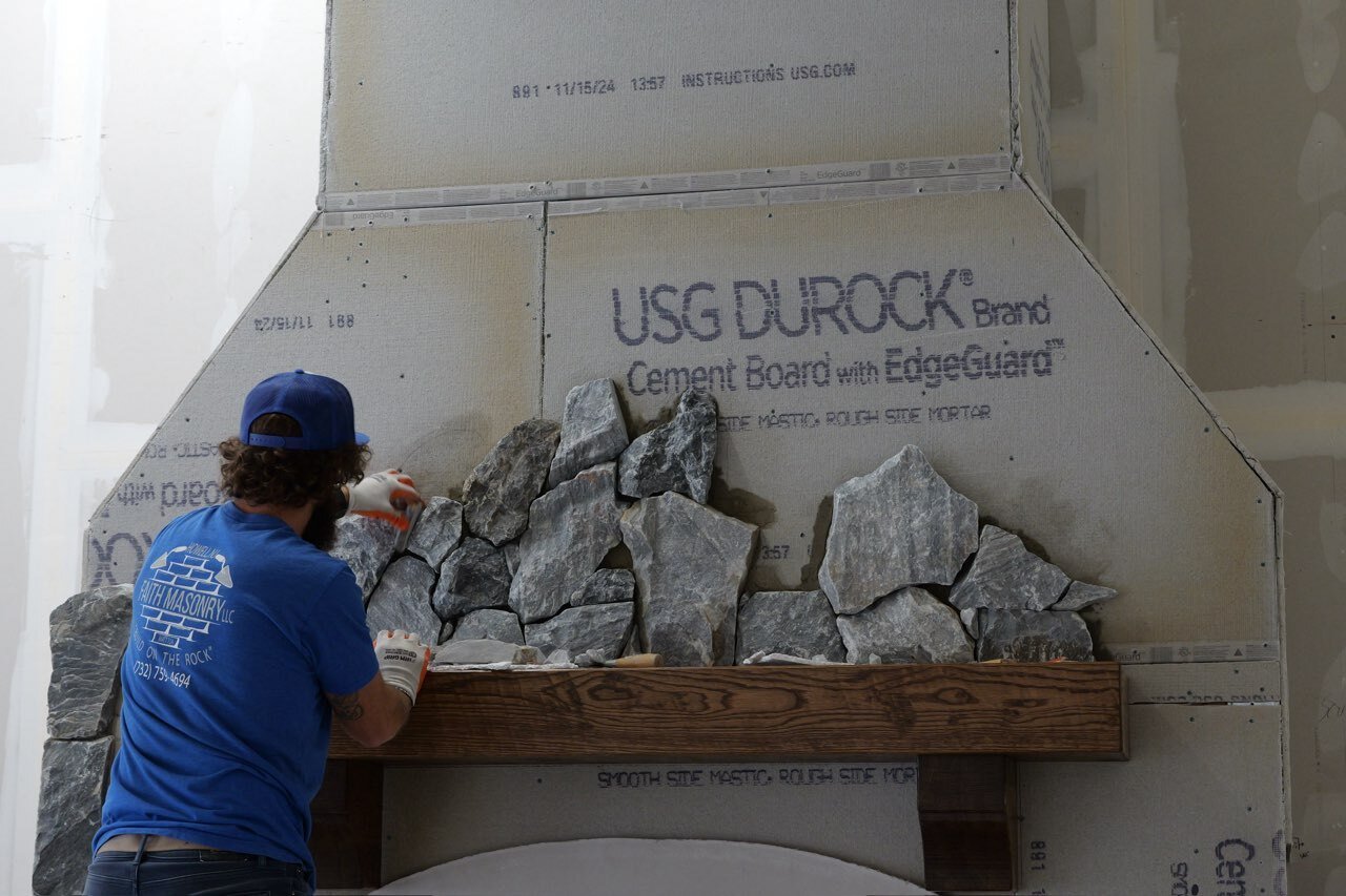 Delos-Coffee-Shop-2 Mid-Installation - Delos TerraForm Irregular Black and Grey Stone Cladding on a large fireplace