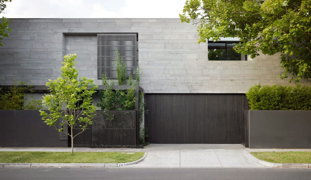 Platinum PLANC Lavastone adorns a modern home with a black base and garage entryway