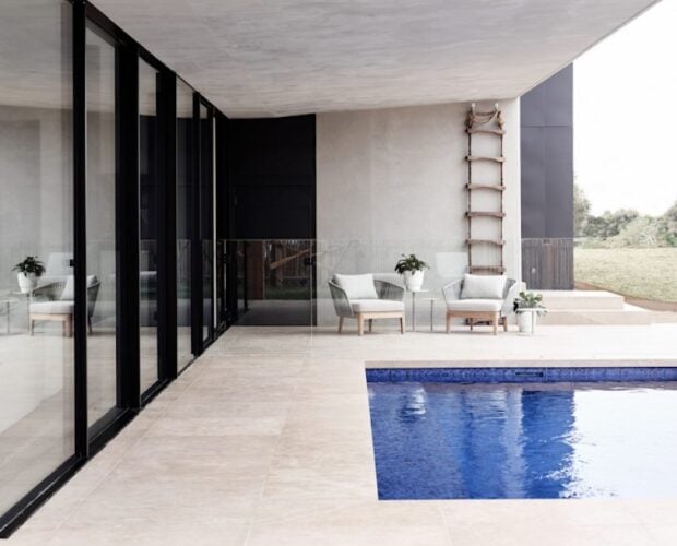 Dune limestone exterior pool pavers in a warm neutral finish around a contemporary outdoor swimming pool
