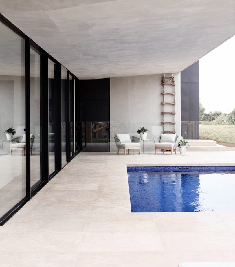 Dune limestone exterior pool pavers in a warm neutral finish around a contemporary outdoor swimming pool
