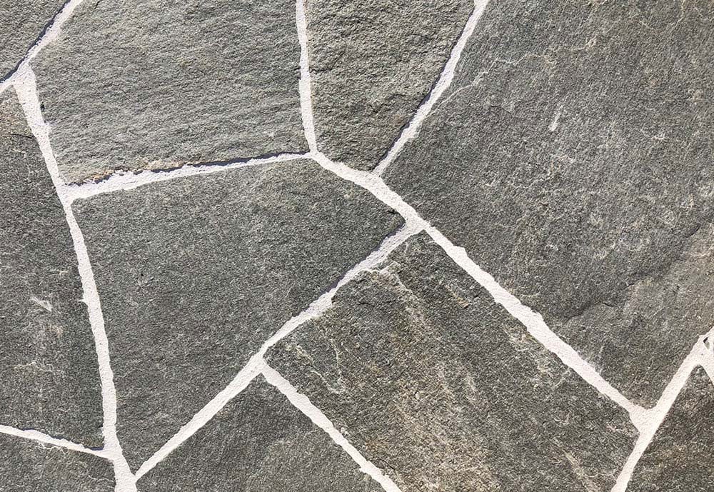Split stone finished flooring with an irregular natural stone pattern and textured surface