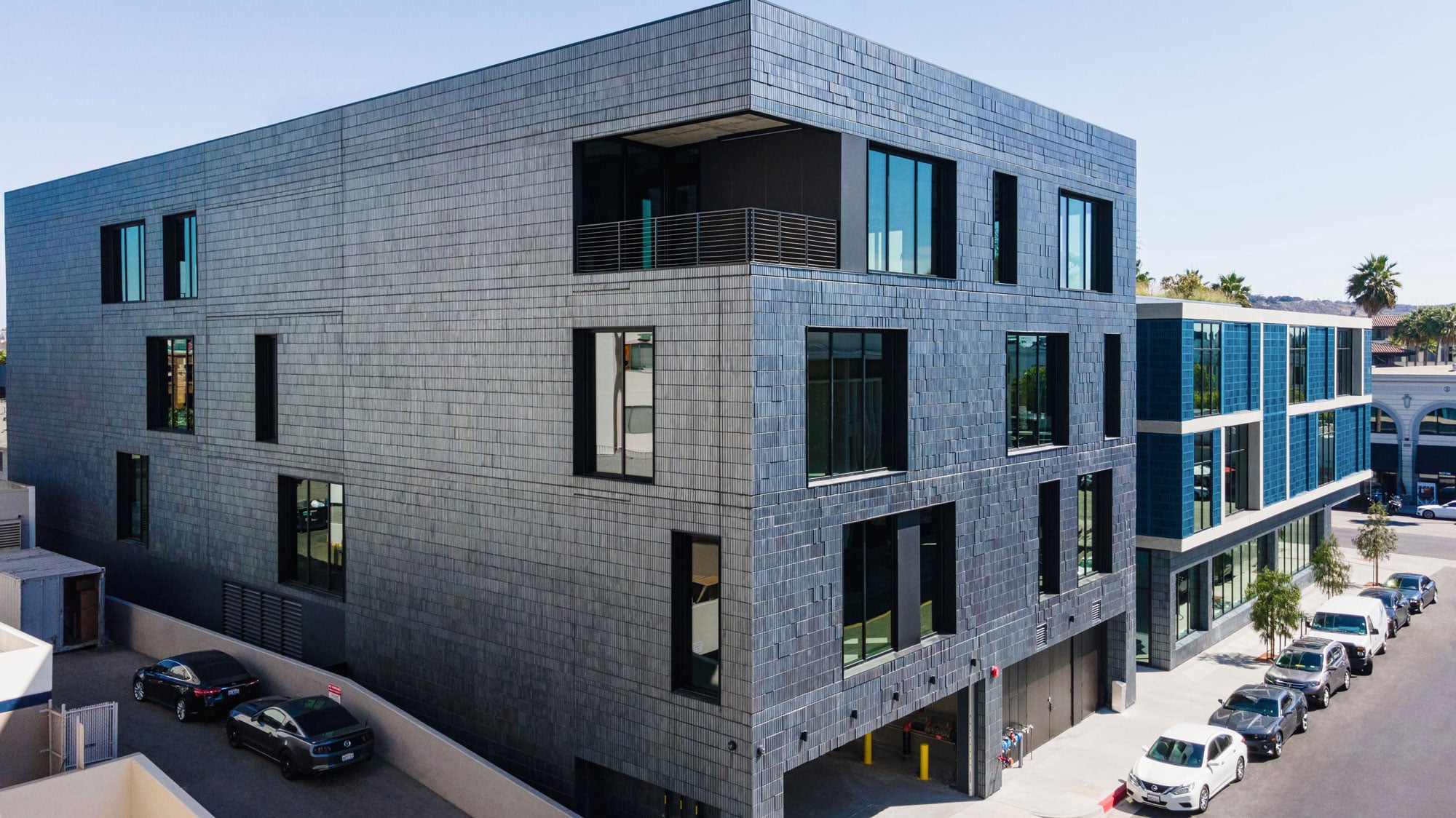 grey brick veneer installed over exterior cinder block walls of this exterior facade