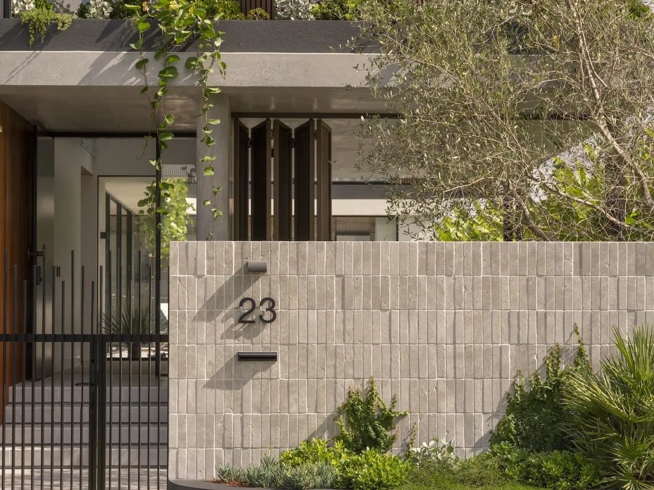 Tumbled grey stone bricks soldier stacked vertically is an excellent idea on how to make cinder block wall look nice