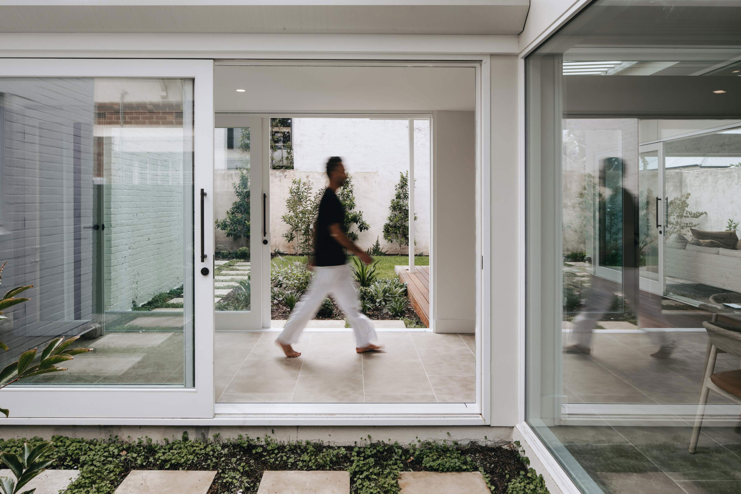 Mesa limestone flooring in a breezeway with warm neutral stone tiles and an indoor-outdoor architectural feel