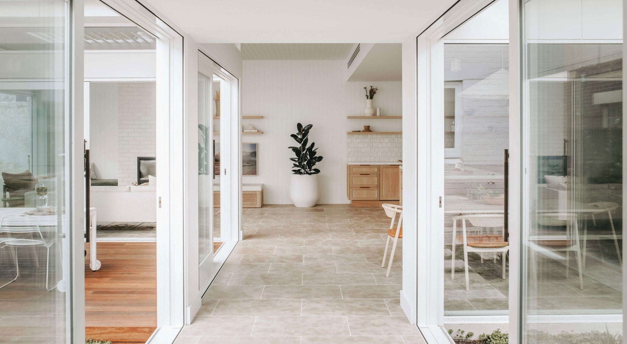 Mesa tumbled limestone flooring in a beautiful walkway and living room